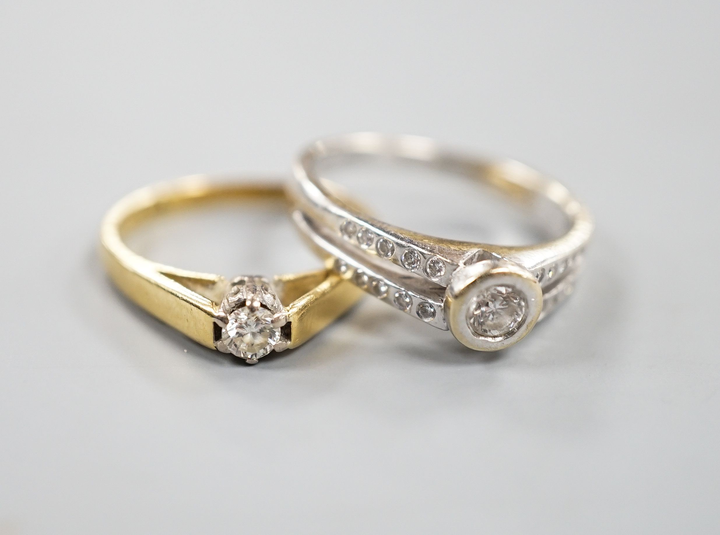 Two 18ct gold and diamond rings, including solitaire and white gold single stone, with diamond set shoulders, sizes, K & M, gross 6.5 grams.